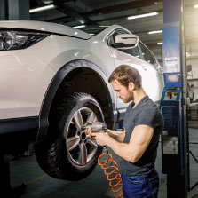 a mechanic working on a car in our auto repair shop